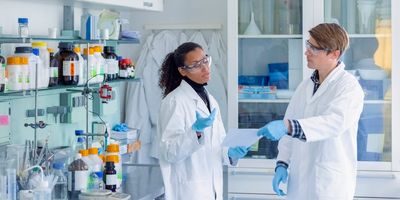 Two scientists have a discussion in the lab