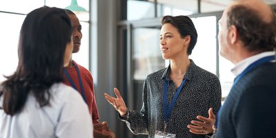 Woman telling fellow conferencegoers about her organization